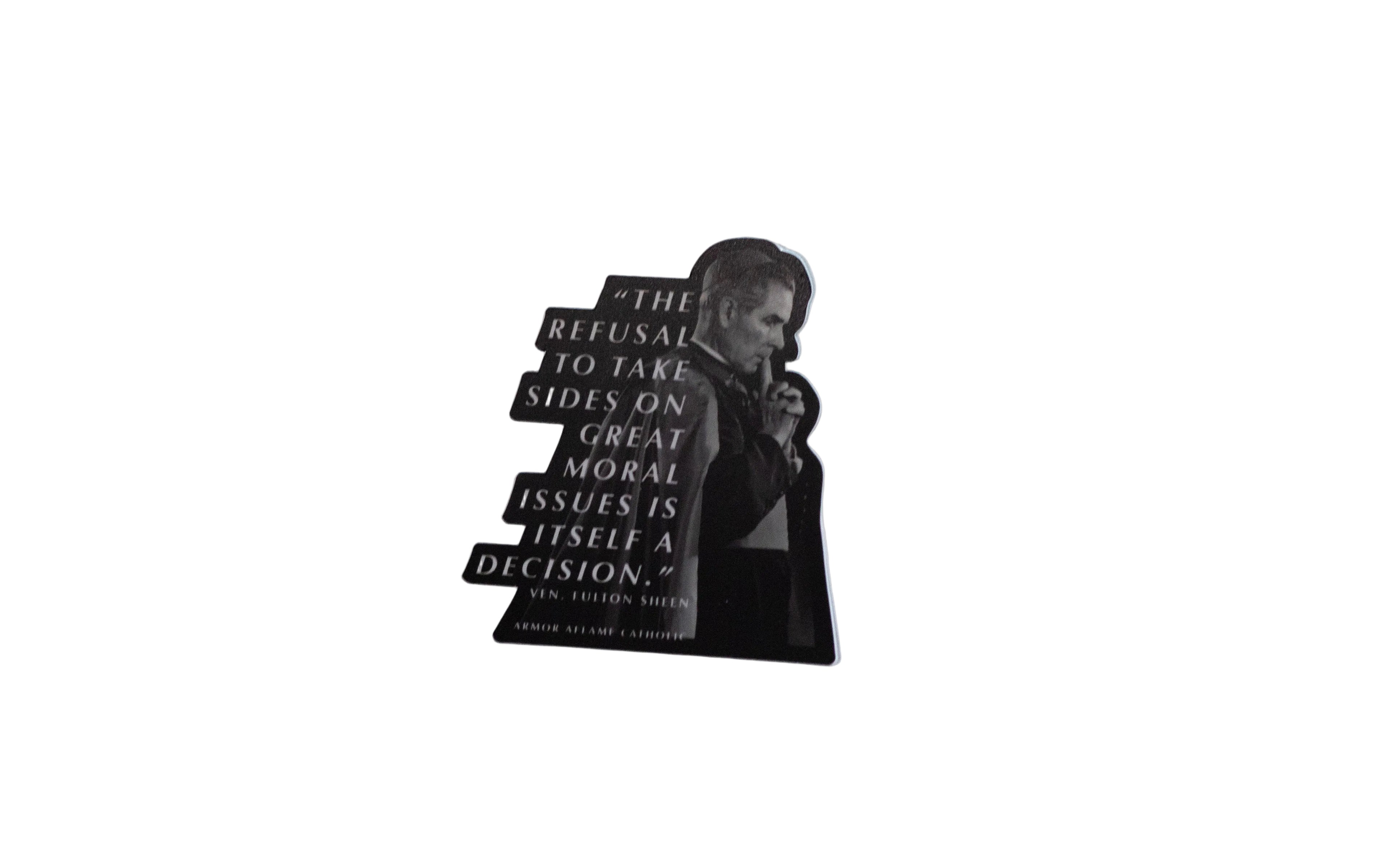 A sticker featuring a black and white image of Fulton Sheen with a quote on it.